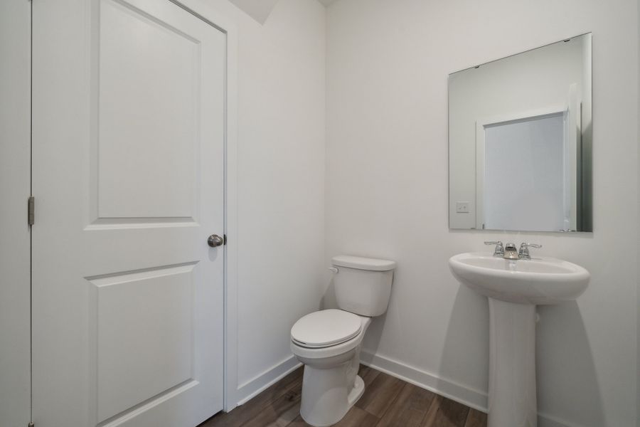 A bathroom with a toilet and sink. A bathroom with a toilet and sink.