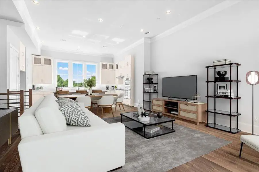 Living area with ornamental molding, wood finished floors, and recessed lighting