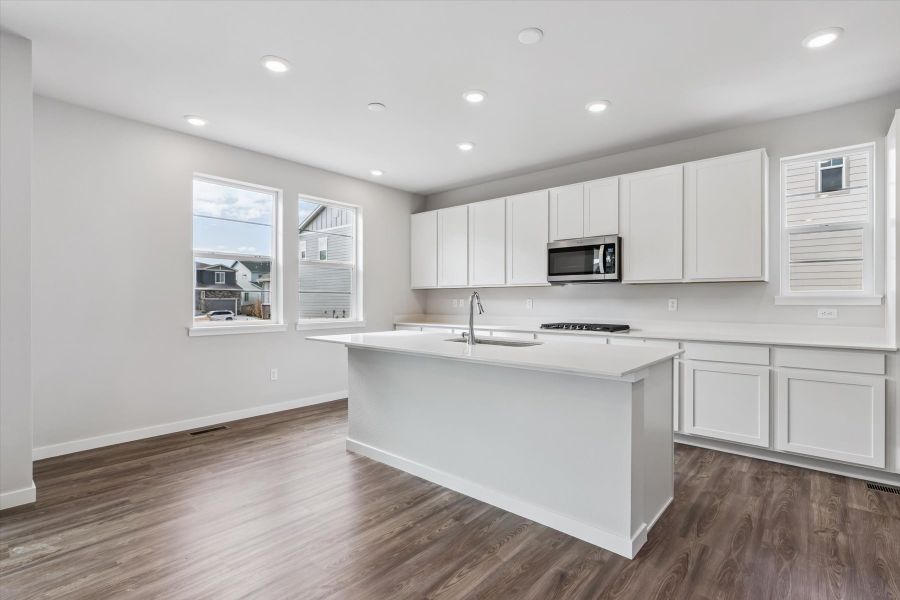 A kitchen with white cabinets.