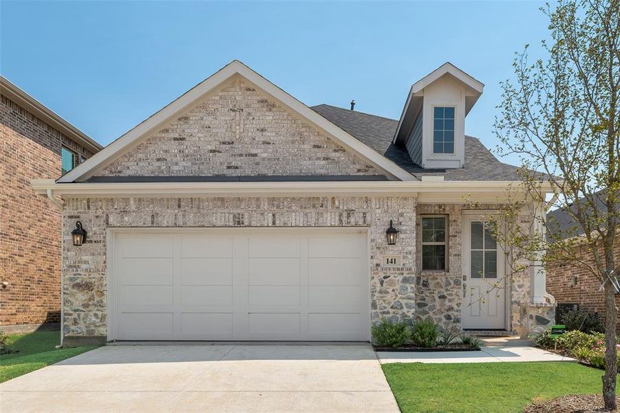 Front exterior of a new home in Spiritas Ranch, Little Elm, TX, highlighting curb appeal (Image 17). Front exterior of a new home in Spiritas Ranch, Little Elm, TX, highlighting curb appeal (Image 17).
