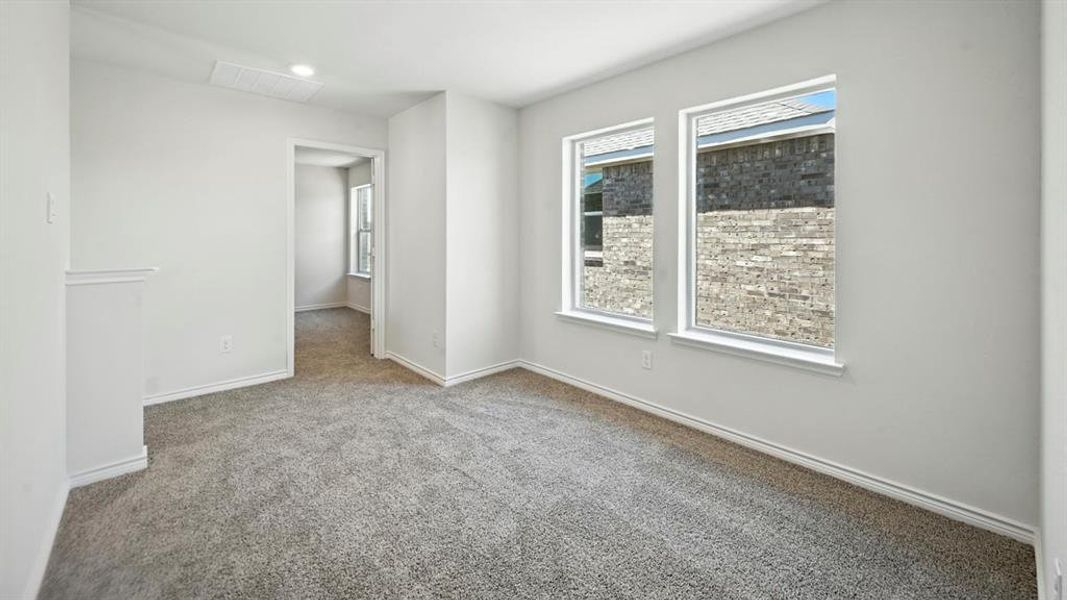 Carpeted spare room with baseboards