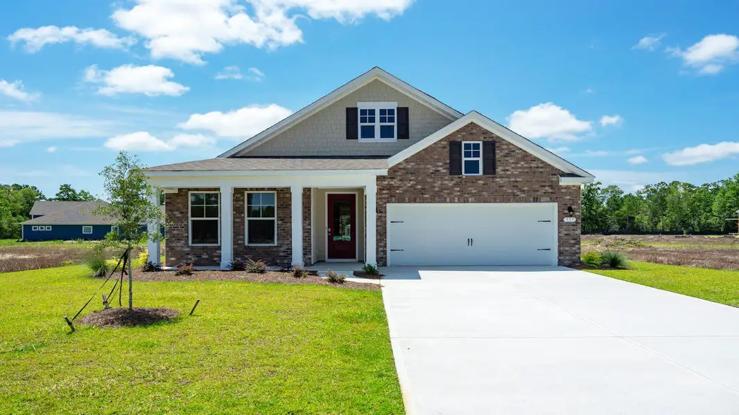 Front exterior of a new home in Brunswick Plantation, Ash, NC, highlighting curb appeal (Image 2). Front exterior of a new home in Brunswick Plantation, Ash, NC, highlighting curb appeal (Image 2).