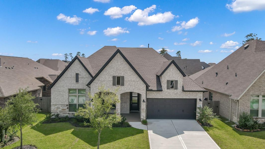 Front exterior of a new home in The Meadows at Imperial Oaks, Conroe, TX, highlighting curb appeal (Image 18). Front exterior of a new home in The Meadows at Imperial Oaks, Conroe, TX, highlighting curb appeal (Image 18).