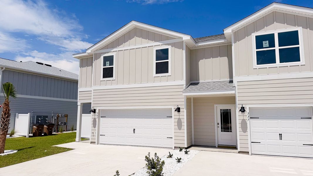 Front exterior of a new home in WindMark Beach, Port Saint Joe, FL, highlighting curb appeal (Image 24).