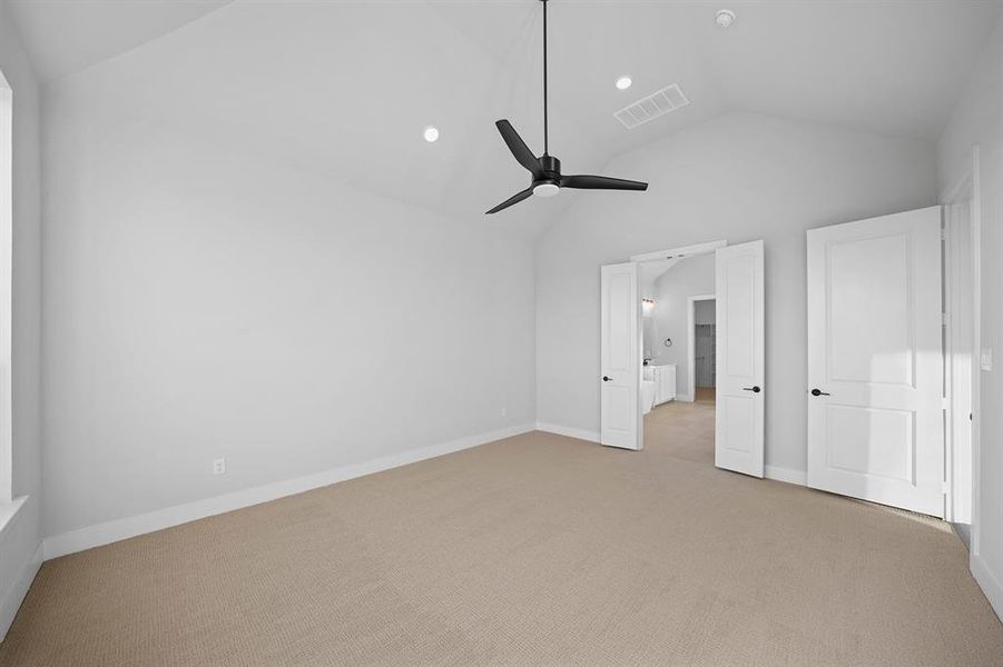 Unfurnished bedroom featuring light colored carpet, ceiling fan, recessed lighting, and high vaulted ceiling Unfurnished bedroom featuring light colored carpet, ceiling fan, recessed lighting, and high vaulted ceiling