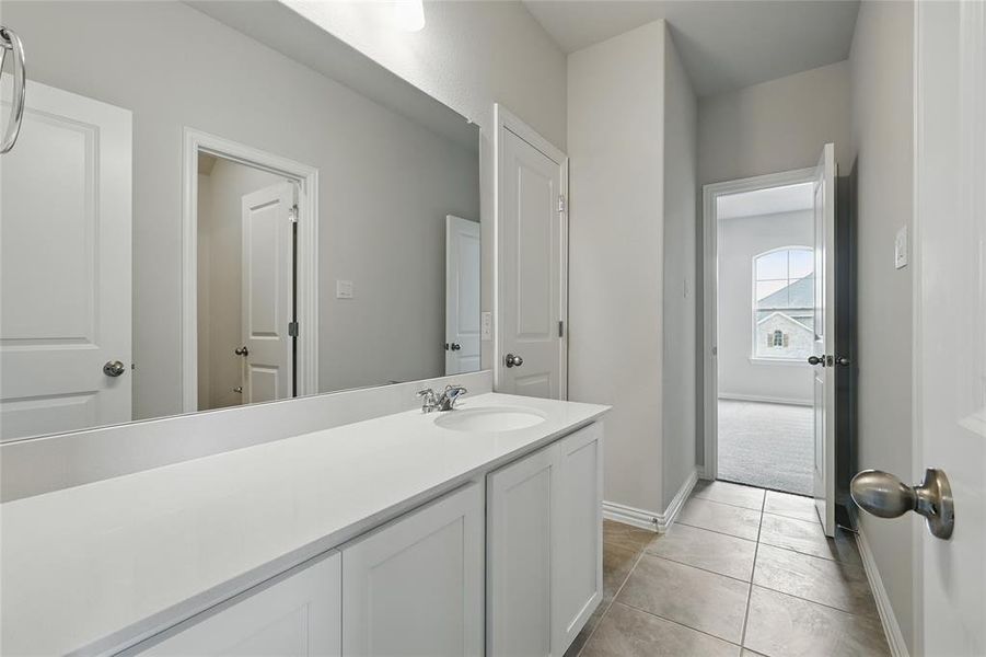 Bathroom with vanity and light tile patterned floors