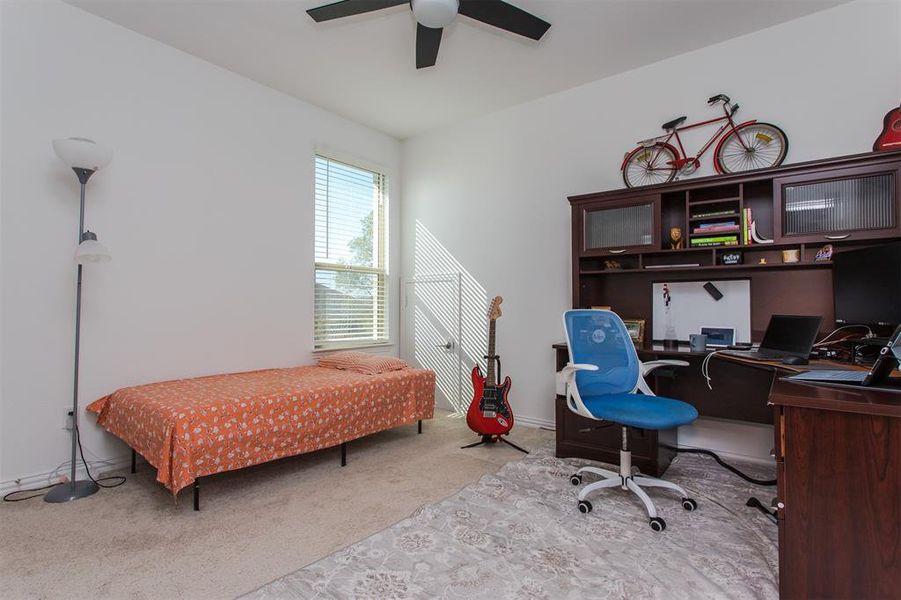 Bedroom featuring ceiling fan and light carpet