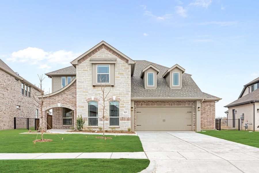 Two-story home with stone and brick exterior, two-car garage, and green front lawn Two-story home with stone and brick exterior, two-car garage, and green front lawn