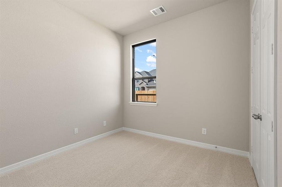 Your secondary bedroom features plush carpet, fresh paint, closet, and a large window that lets in plenty of natural lighting.