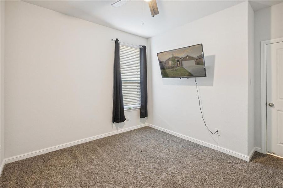 Carpeted spare room featuring ceiling fan Carpeted spare room featuring ceiling fan