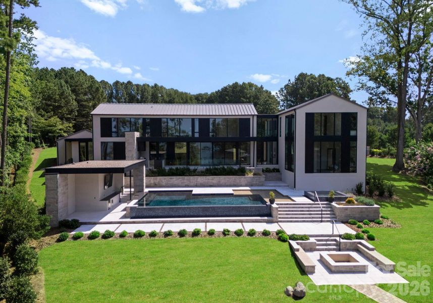 Aerial view of the backyard, including the pool, spa, fire pit, and outdoor kitchen. Aerial view of the backyard, including the pool, spa, fire pit, and outdoor kitchen.