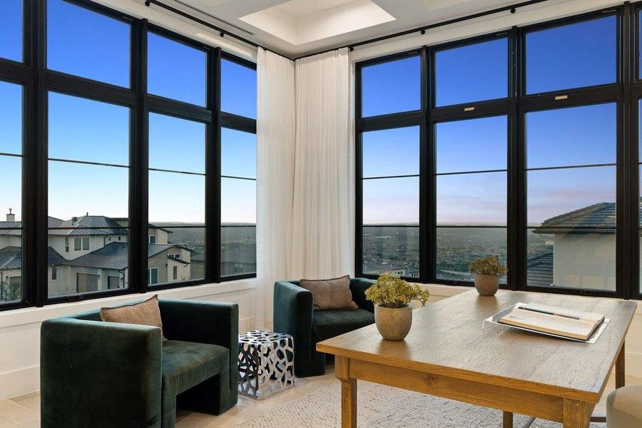 Vast window walls frame a captivating cityscape, providing a dynamic backdrop for comfortable living.