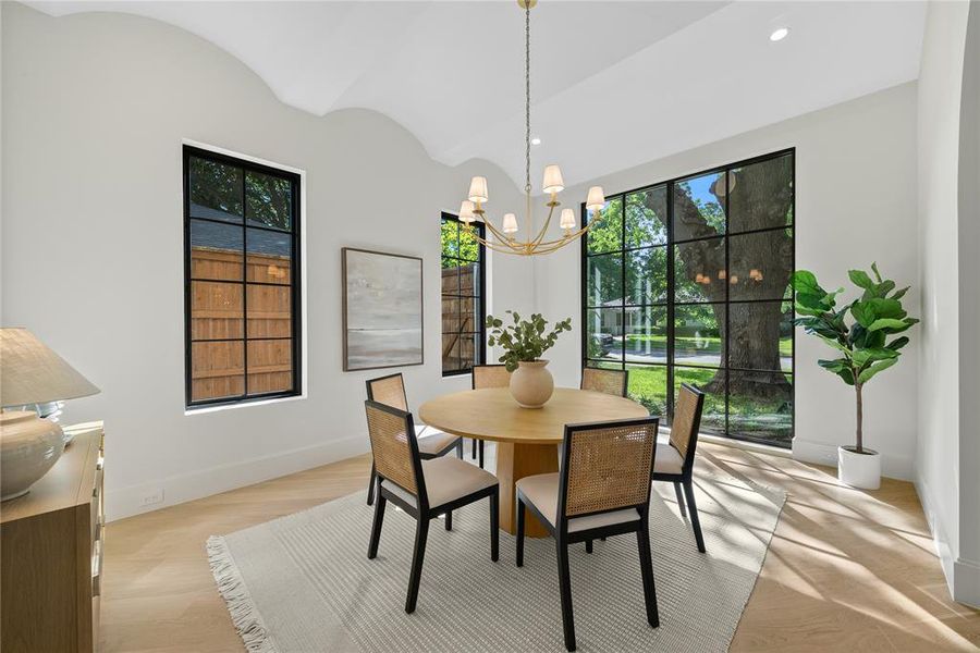 Light wood-finish flooring complements the tall white walls