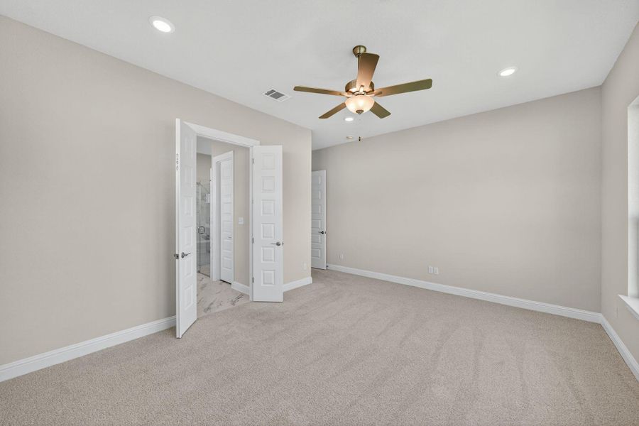 Unfurnished bedroom with light carpet, a ceiling fan, and recessed lighting Unfurnished bedroom with light carpet, a ceiling fan, and recessed lighting