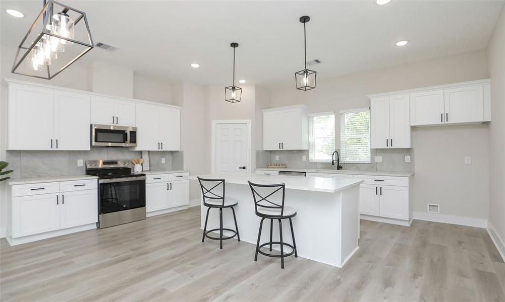 Plenty of storage and windows over the kitchen sink for tons of natural light.