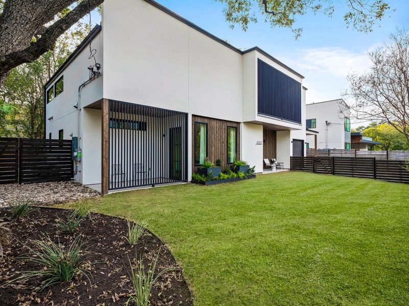 View of front of home, this home has a covered porch, a balcony and one back porch