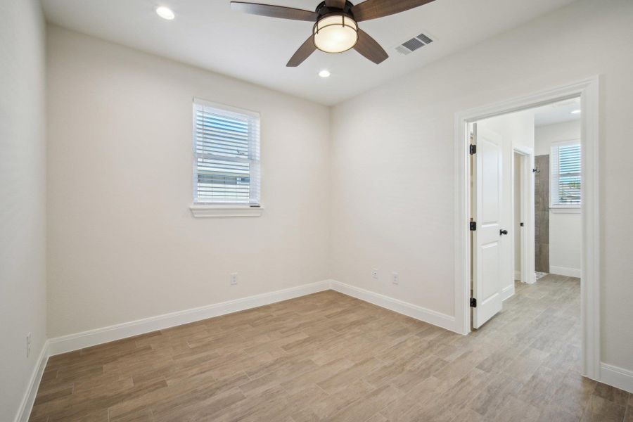 Primary Bedroom featuring baseboards, visible vents, light wood-style floors, and a ceiling fan Primary Bedroom featuring baseboards, visible vents, light wood-style floors, and a ceiling fan