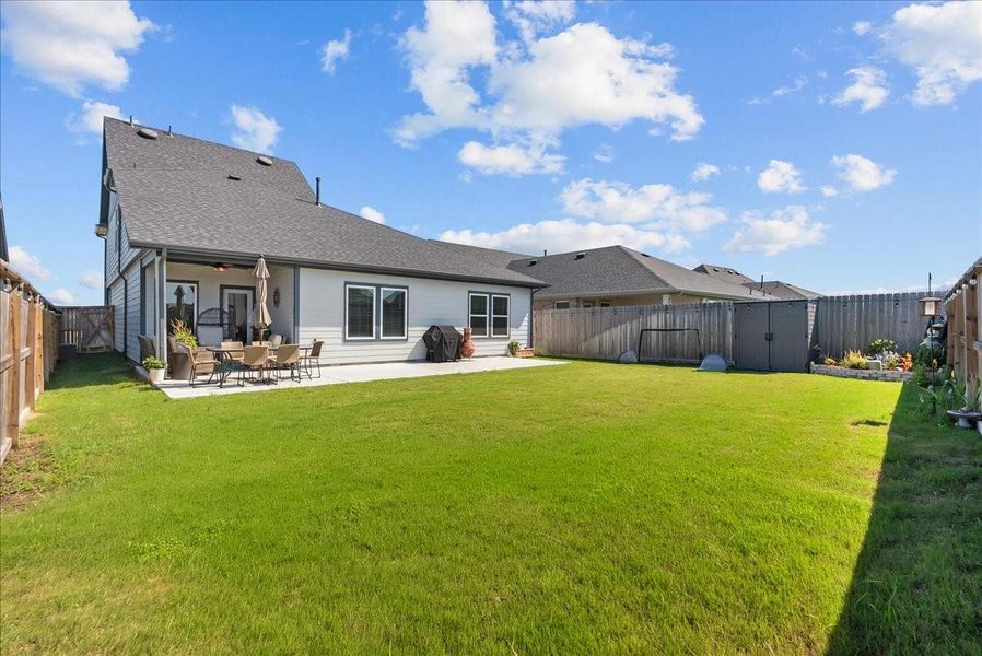 Enjoy the covered back patio overlooking the nice-sized backyard with plenty of space to relax, play, or entertain.