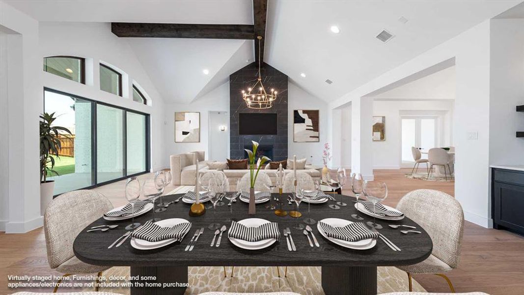 Dining room with a healthy amount of sunlight, wood-type flooring, and beamed ceiling