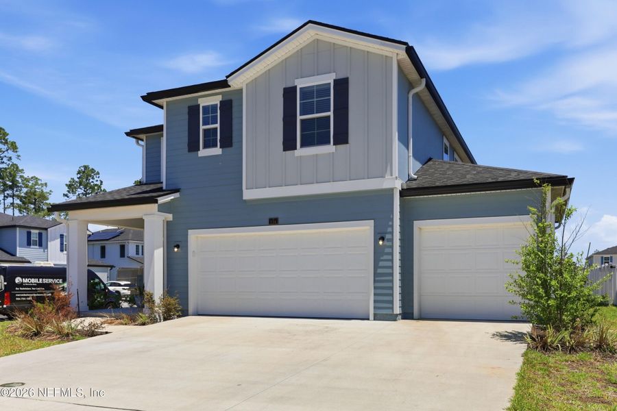Front exterior of a new home in Cordova Palms, St. Augustine, FL, highlighting curb appeal (Image 22). Front exterior of a new home in Cordova Palms, St. Augustine, FL, highlighting curb appeal (Image 22).