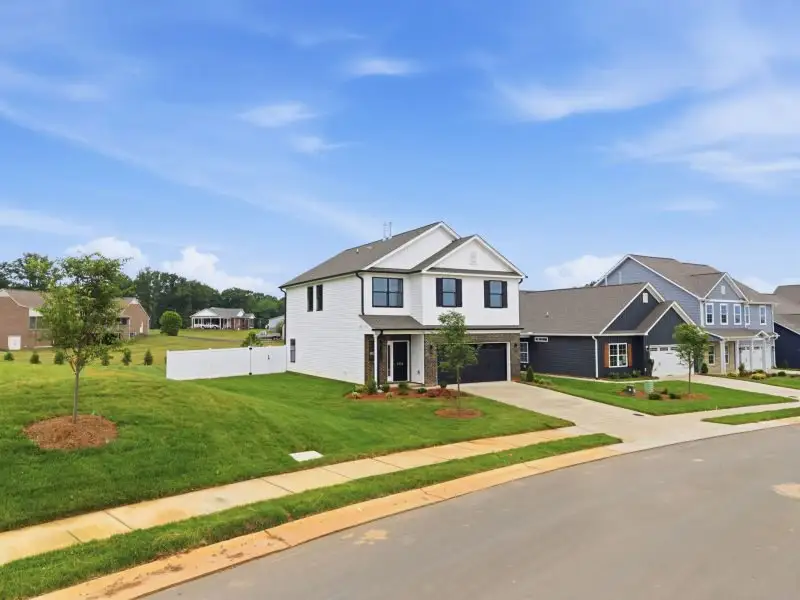 Front exterior of a new home in Sullivans Reserve, Walkertown, NC, highlighting curb appeal (Image 2). Front exterior of a new home in Sullivans Reserve, Walkertown, NC, highlighting curb appeal (Image 2).
