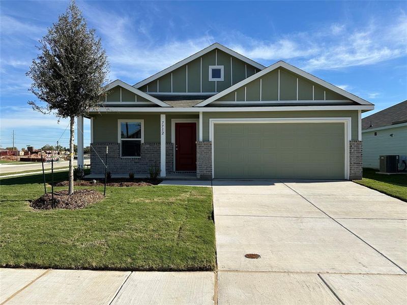 Craftsman-style house with cooling unit, a front lawn, a porch, and a garage