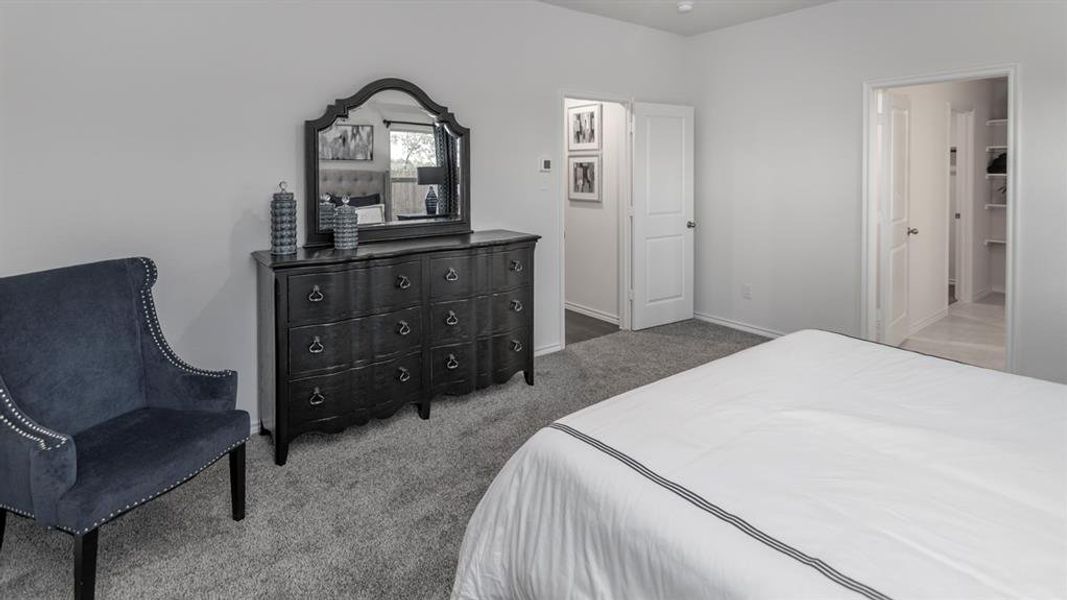 Bedroom featuring light-colored walls and grey carpeting