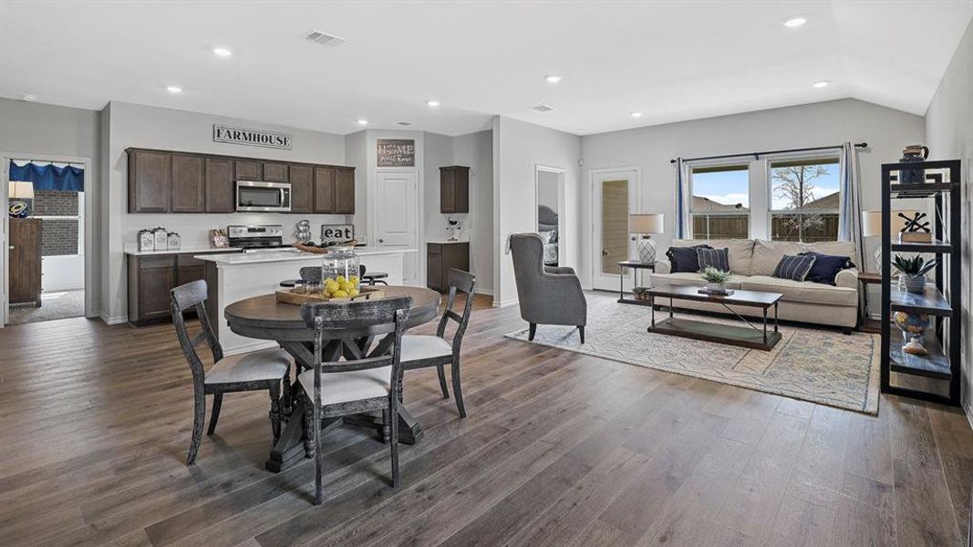 Open-concept living space featuring wood-finish flooring throughout
