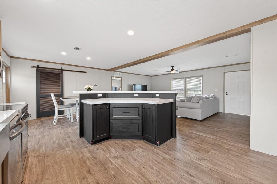 Angle displaying the connection between kitchen, dining, and living areas, reinforcing the open-concept design. Angle displaying the connection between kitchen, dining, and living areas, reinforcing the open-concept design.