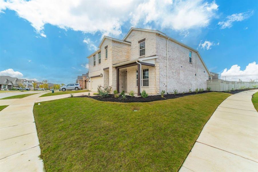 View of side of property featuring brick siding, concrete driveway, a residential view, and a garage View of side of property featuring brick siding, concrete driveway, a residential view, and a garage