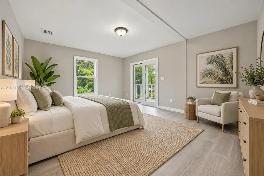 Bedroom featuring wood-finish flooring, a single window, and sliding glass doors with exterior balcony access Bedroom featuring wood-finish flooring, a single window, and sliding glass doors with exterior balcony access