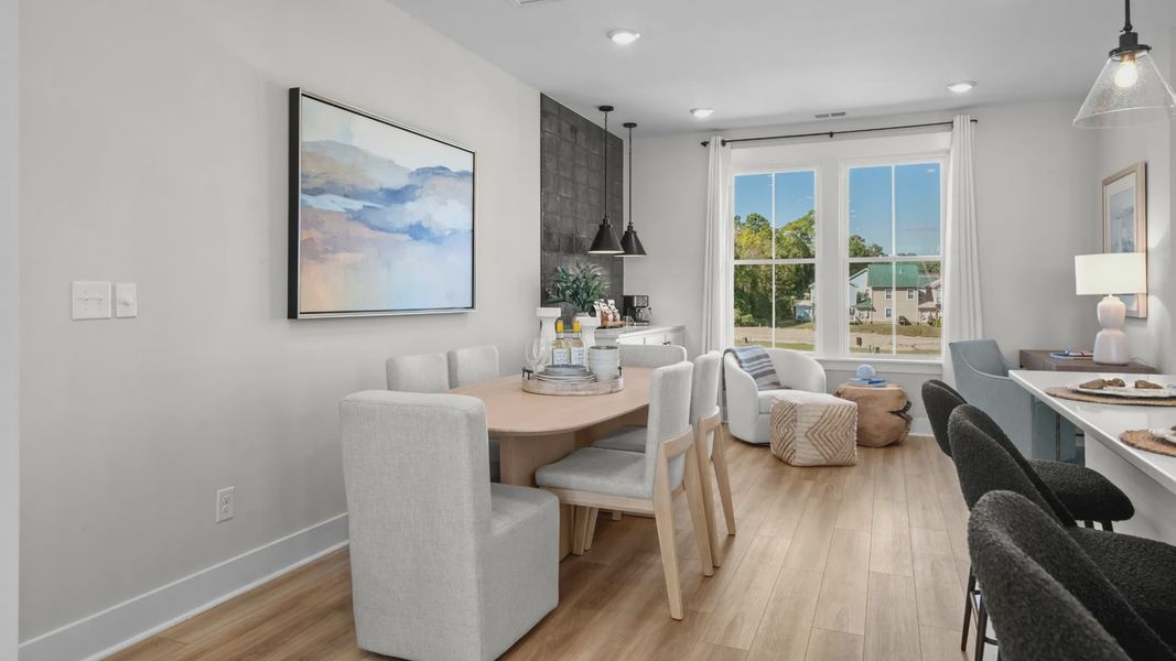 Island kitchen & dining area with 2 large windows in a DRB Homes Brookgreen model home Island kitchen & dining area with 2 large windows in a DRB Homes Brookgreen model home
