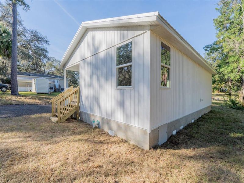 Exterior details and patio area of a home in , Fort McCoy (Image 12).