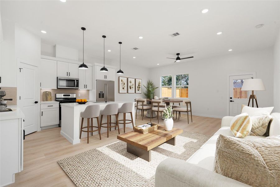 Bright, modern kitchen with white cabinetry, stainless steel appliances, and a spacious island with seating. Features include high ceilings, recessed and pendant lighting, ample counter space, and a walk-in pantry. *Virtually Staged Bright, modern kitchen with white cabinetry, stainless steel appliances, and a spacious island with seating. Features include high ceilings, recessed and pendant lighting, ample counter space, and a walk-in pantry. *Virtually Staged