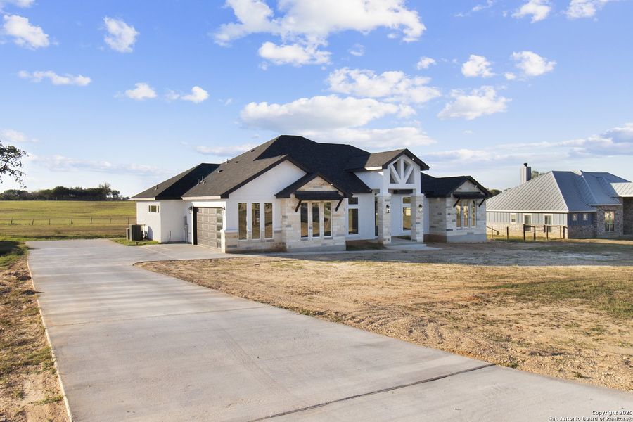 Front exterior of a new home in , Adkins, TX, highlighting curb appeal (Image 2).