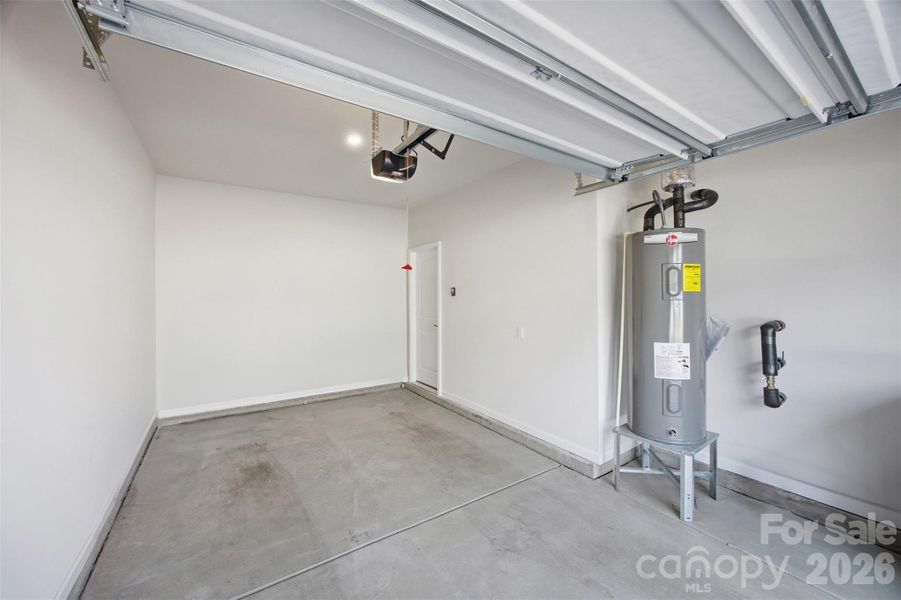 Garage, Hot water heater and entrance to home throught the garage