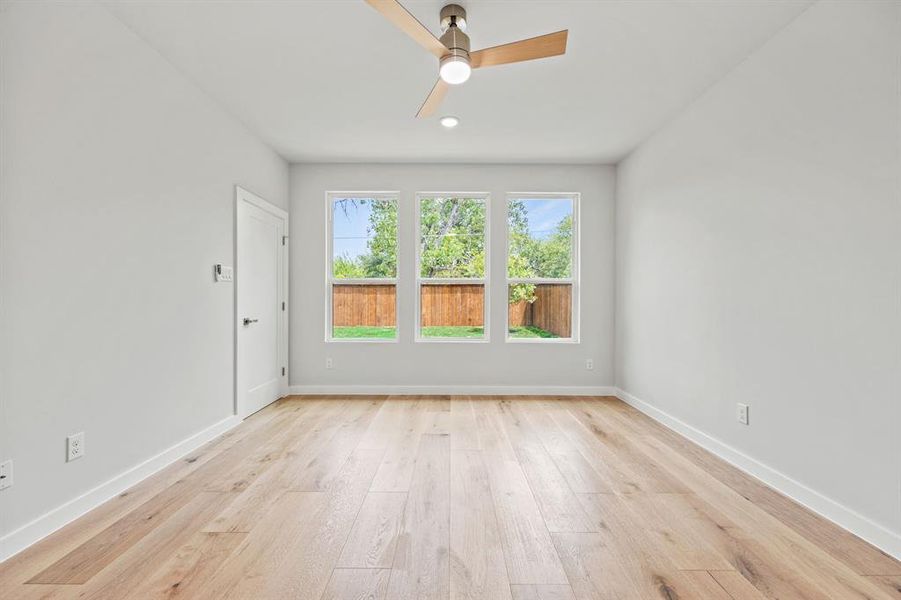 Unfurnished room with light hardwood / wood-style floors and ceiling fan