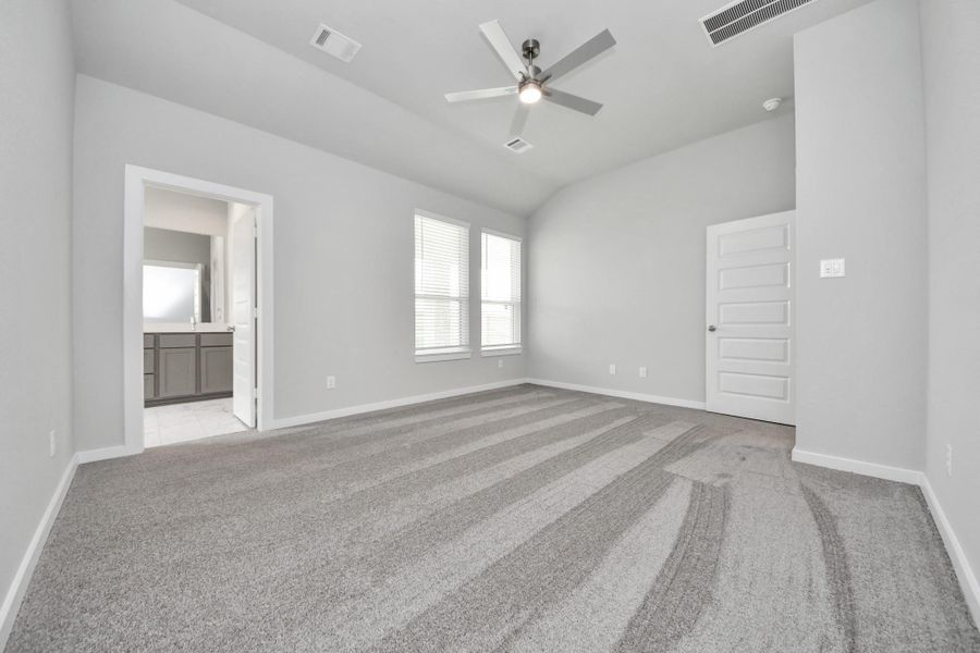 Escape to tranquility in this spacious primary room, adorned with plush carpeting and bathed in the soothing hues of warm paint colors, creating a cozy retreat for relaxation. Escape to tranquility in this spacious primary room, adorned with plush carpeting and bathed in the soothing hues of warm paint colors, creating a cozy retreat for relaxation.