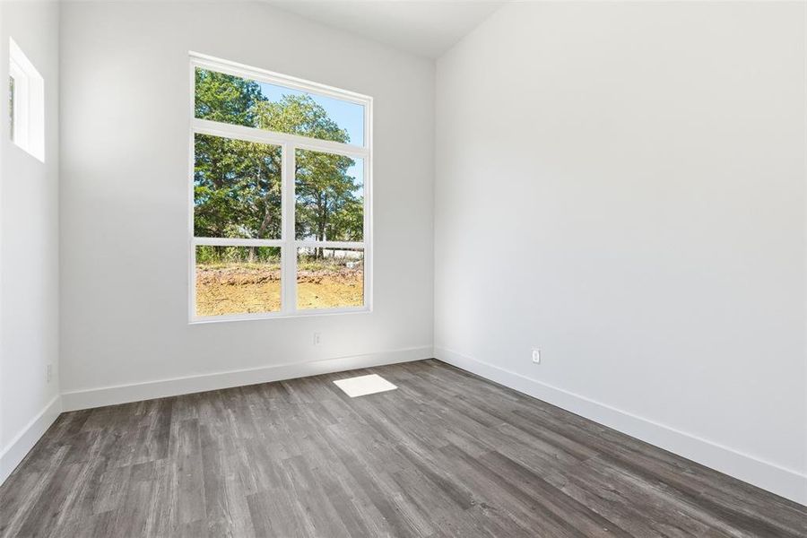 Empty room with wood finished floors and baseboards Empty room with wood finished floors and baseboards