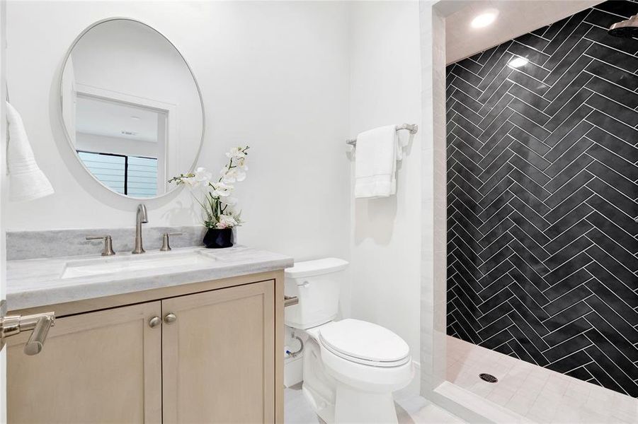 bathroom for the third floor en-suite bedroom. Custom cabinets, real stone counter tops.