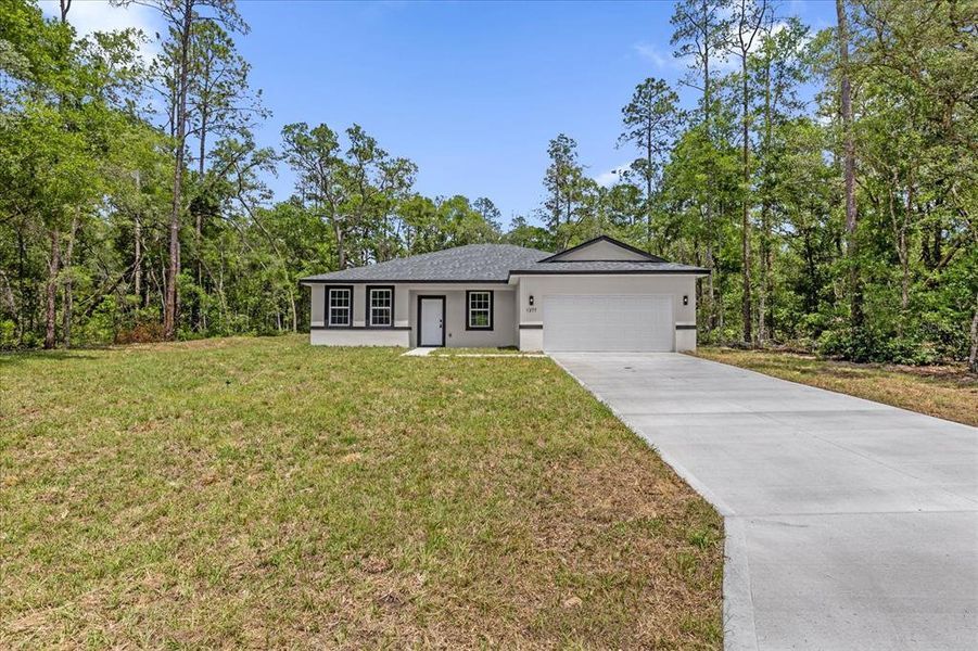 Front exterior of a new home in , Citrus Springs, FL, highlighting curb appeal (Image 22).
