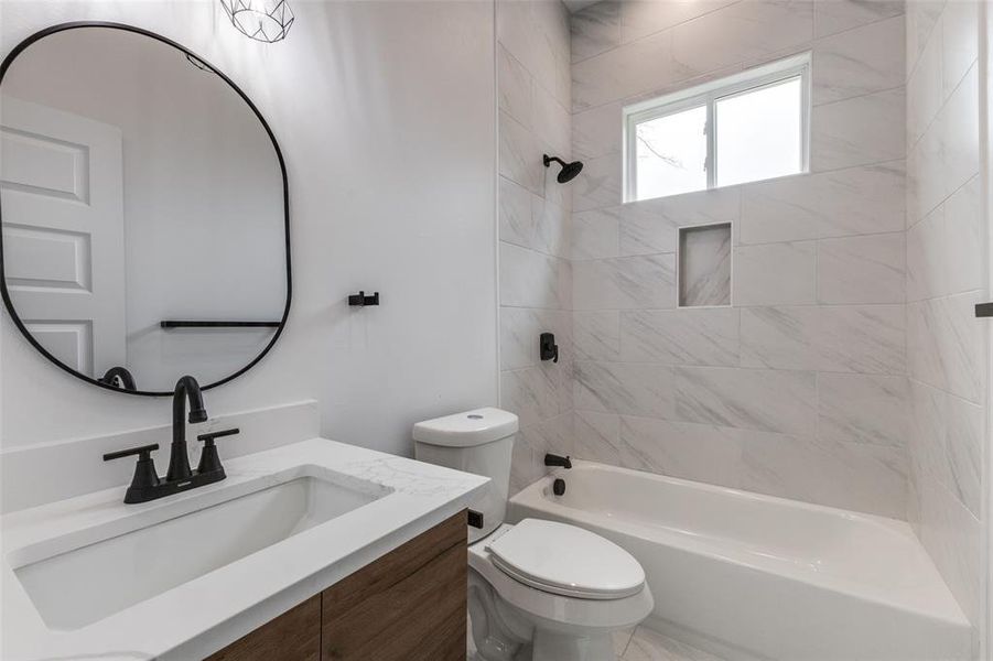 Bathroom with tub / shower combination, toilet, and vanity