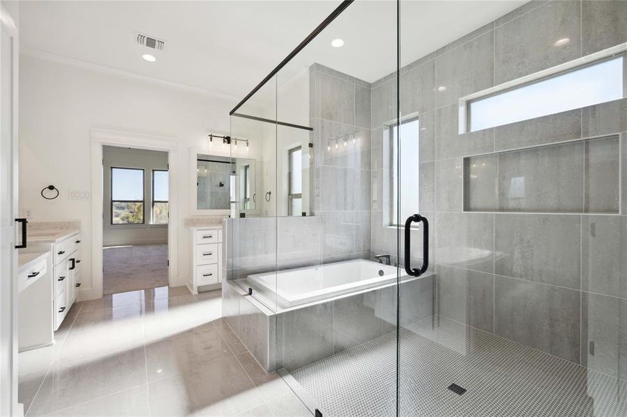 Bathroom with tile patterned floors, vanity, and shower with separate bathtub