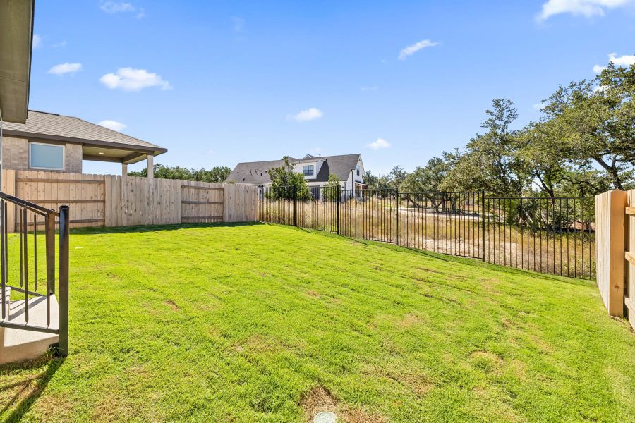 Exterior details and patio area of a home in Lariat, Liberty Hill (Image 24).