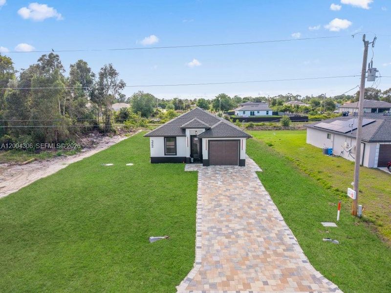 Front exterior of a new home in , Lehigh Acres, FL, highlighting curb appeal (Image 20).