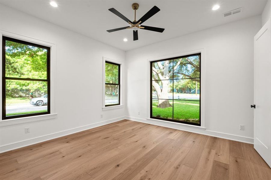 Guest bedroom downstairs featuring light wood-style flooring, recessed lighting, and ceiling fan Guest bedroom downstairs featuring light wood-style flooring, recessed lighting, and ceiling fan