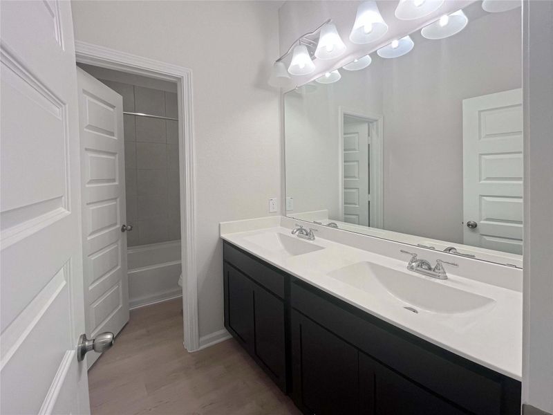 Secondary Bathroom with Dual Sinks. Home under construction. Sample floor plan photo used for illustrative purposes only. Upgrades, selections options, windows and colors may vary.