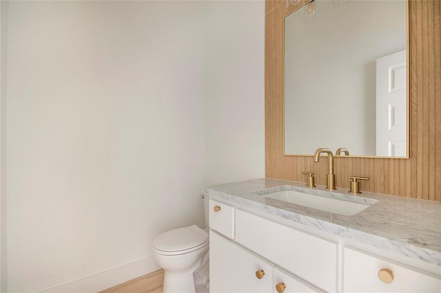 Half bath with vanity and light wood-style floors Half bath with vanity and light wood-style floors