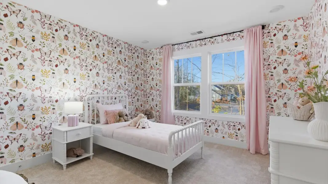 Tasteful bedroom with plush carpet, a walk-in closet, and large windows for abundant natural light at the Lawson Design