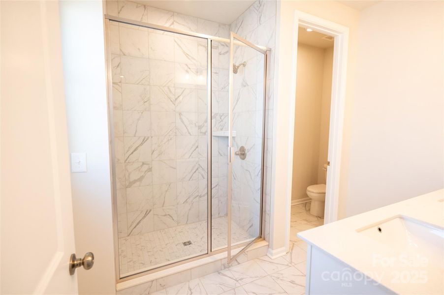 Modern tile and floor pan at primary shower.